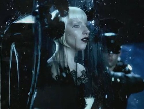 Only Gaga can make a funeral scene chic. The singer covers herself with a delicate black veil with rosette details.
Only Gaga can make a funeral scene chic. The singer covers herself with a delicate black veil with rosette details.