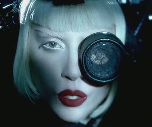 Gaga with one eye open, one eye in spectacle lace. Doesn't she look like Madonna here?
Gaga with one eye open, one eye in spectacle lace. Doesn't she look like Madonna here?