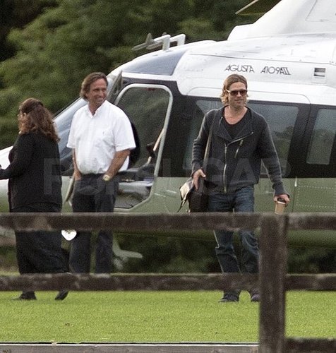 Brad Pitt carries a cup of coffee getting off the helicopter.
Brad Pitt carries a cup of coffee getting off the helicopter.