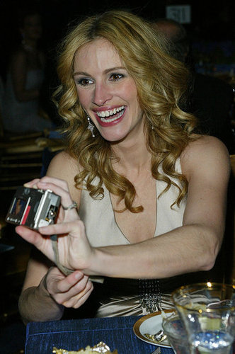 At the Academy Awards Governors Ball in 2004, Julia Roberts got a kick out of her own photos.
At the Academy Awards Governors Ball in 2004, Julia Roberts got a kick out of her own photos.