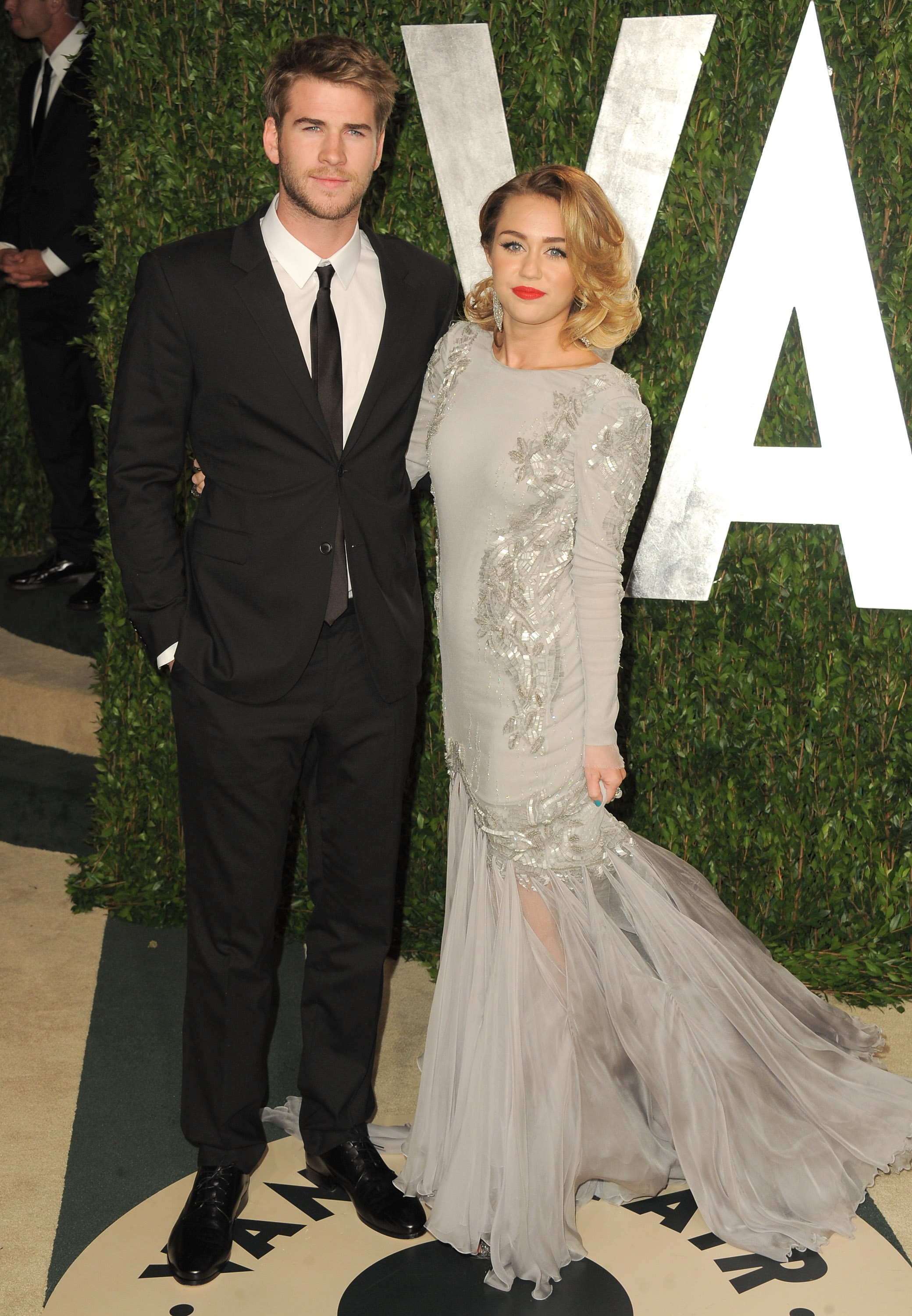 Miley Cyrus and Liam Hemsworth strike a post at Vanity Fair. Miley Cyrus and Liam Hemsworth strike a post at Vanity Fair.