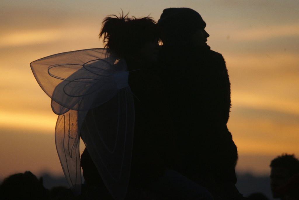 This couple got close to watch the sunrise at the Glastonbury Festival in England.
This couple got close to watch the sunrise at the Glastonbury Festival in England.