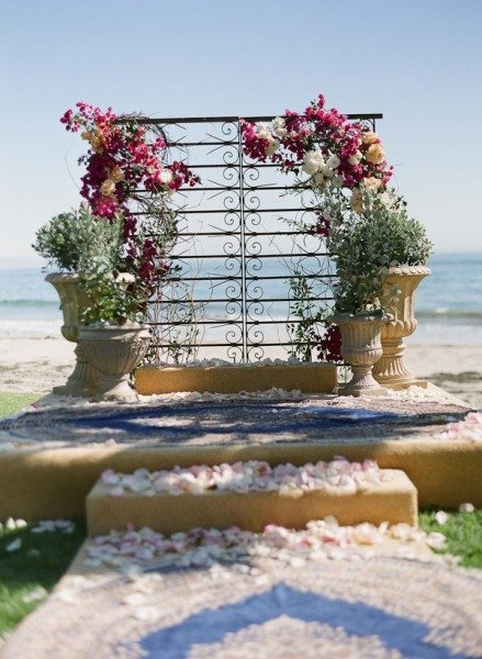 With large potted plants and gorgeous, sprawling flowers, a sculptural piece is transformed into a beautiful backdrop that's perfect for a romantic beach wedding.
Photo by Braedon Photography via Style Me Pretty
With large potted plants and gorgeous, sprawling flowers, a sculptural piece is transformed into a beautiful backdrop that's perfect for a romantic beach wedding.
Photo by Braedon Photography via Style Me Pretty