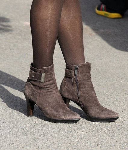 A close-up of Kate's heeled suede brown booties.
A close-up of Kate's heeled suede brown booties.