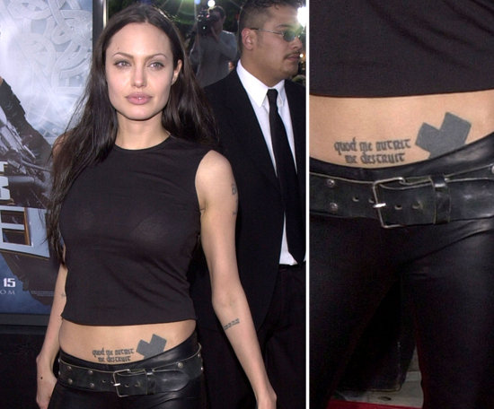 Angelina Jolie got a dragon tattoo on her abdomen during a drunk night in Amsterdam, and later covered it up with a large black cross. She also has ab ink of the Latin words "quod me nutrit me destruit," which means, "what nourishes me, destroys me."
Angelina Jolie got a dragon tattoo on her abdomen during a drunk night in Amsterdam, and later covered it up with a large black cross. She also has ab ink of the Latin words "quod me nutrit me destruit," which means, "what nourishes me, destroys me."