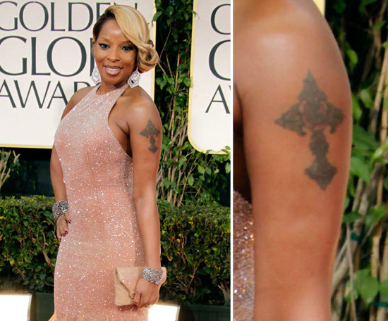 Mary J. Blige belts out big hits, and when it comes to tattoos she goes big. Mary has a large cross on her left arm and her name on her right.
Mary J. Blige belts out big hits, and when it comes to tattoos she goes big. Mary has a large cross on her left arm and her name on her right.