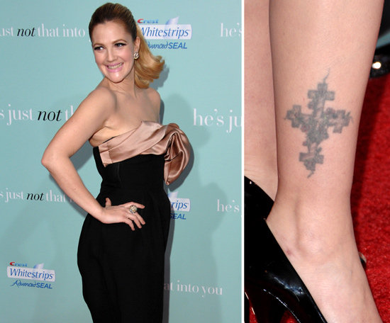 Drew Barrymore has a large cross covered in vines on her right ankle.
Drew Barrymore has a large cross covered in vines on her right ankle.