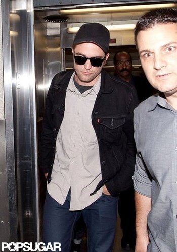 Robert Pattinson arrived at LAX wearing a black hat and sunglasses.
Robert Pattinson arrived at LAX wearing a black hat and sunglasses.