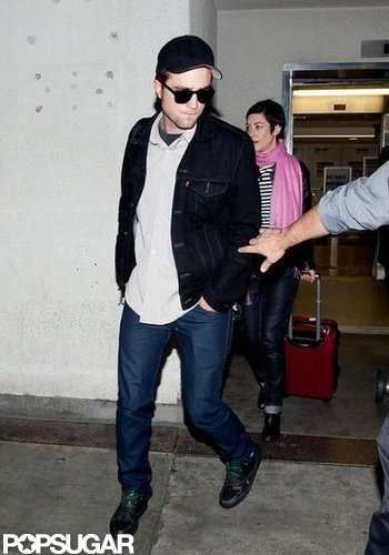Robert Pattinson got off of a plane at LAX wearing a black jacket and jeans.
Robert Pattinson got off of a plane at LAX wearing a black jacket and jeans.