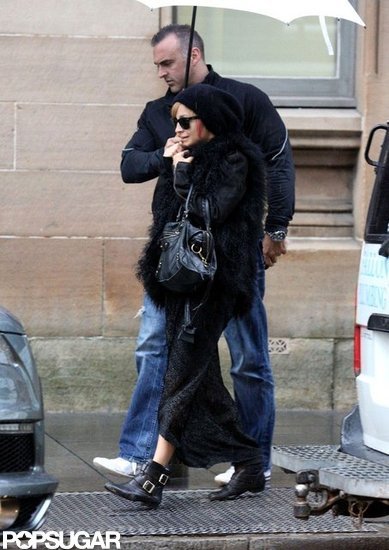 Nicole Richie hid under a white umbrella from the rain in Australia. Nicole Richie hid under a white umbrella from the rain in Australia.