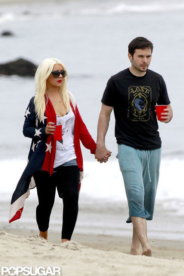 Christina Aguilera and Matthew Rutler walked the beach in Malibu with drinks in hand.
Christina Aguilera and Matthew Rutler walked the beach in Malibu with drinks in hand.