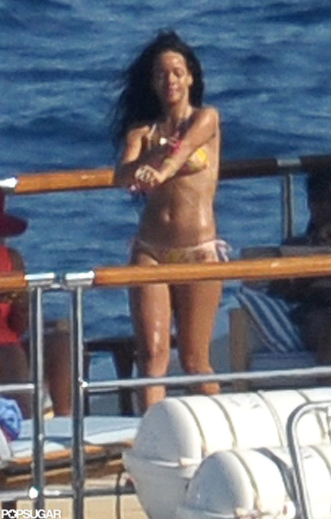 Rihanna relaxed on deck in a two-piece swimsuit. Rihanna relaxed on deck in a two-piece swimsuit.