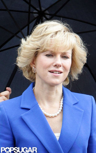 Naomi Watts wore a pearl necklace and blue suit on set.
Naomi Watts wore a pearl necklace and blue suit on set.