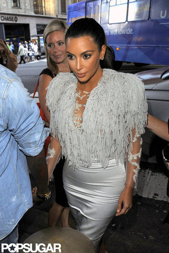 Kim Kardashian held hands with Kanye West.
Kim Kardashian held hands with Kanye West.