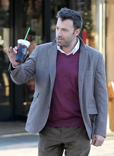 Ben Affleck said hi to someone as he walked across a street.
Ben Affleck said hi to someone as he walked across a street.