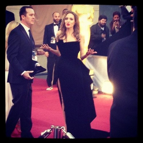 Angelina Jolie, in her now-infamous dress, couldn't seem to find her date, Brad Pitt, at the Oscars.
Angelina Jolie, in her now-infamous dress, couldn't seem to find her date, Brad Pitt, at the Oscars.