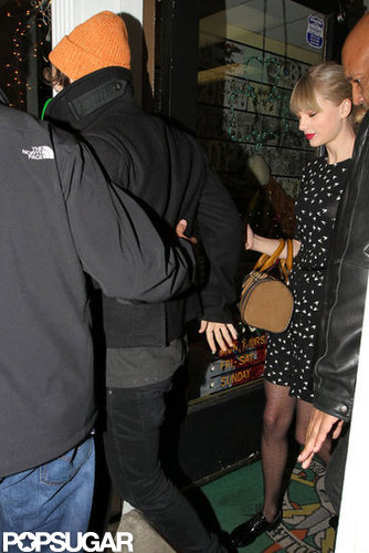 Harry Styles held onto Taylor Swift as they left a tattoo parlor together.
Harry Styles held onto Taylor Swift as they left a tattoo parlor together.
