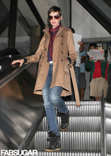 Anne Hathaway's travel style included black Isabel Marant sneakers, skinny jeans, and a dark camel trench coat.
Anne Hathaway's travel style included black Isabel Marant sneakers, skinny jeans, and a dark camel trench coat.