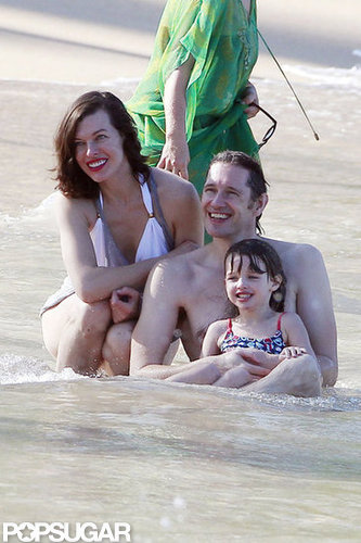 Bikini-Clad Milla Jovovich Poses Beachside With Her Family on NYE Bikini-Clad Milla Jovovich Poses Beachside With Her Family on NYE