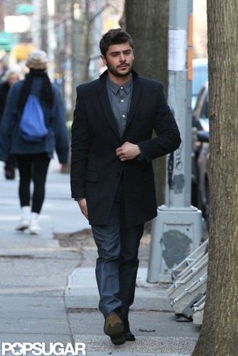 Zac Efron wore jeans and a long coat.
Zac Efron wore jeans and a long coat.
