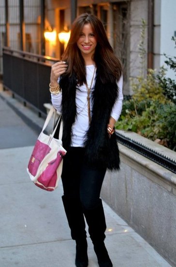 wearing a faux fur vest and leggings