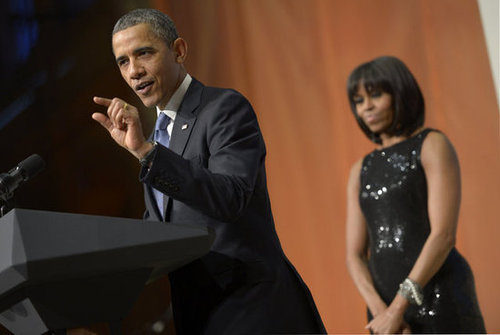 Even in the background, Michelle shines, especially with a little help from this black shimmery Michael Kors gown.
Even in the background, Michelle shines, especially with a little help from this black shimmery Michael Kors gown.