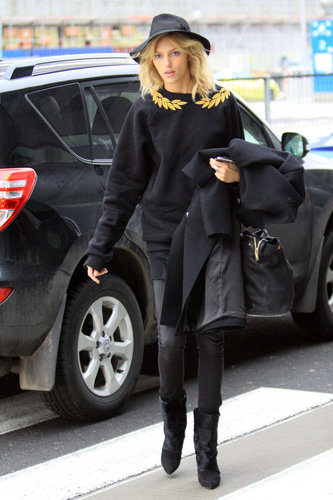Anja Rubik arrived in Poland wearing a black sweater — the gold leaf detailing was the perfect pop of color — black leather pants, black boots, and a black hat. She held onto a black coat and a black leather bag.
Anja Rubik arrived in Poland wearing a black sweater — the gold leaf detailing was the perfect pop of color — black leather pants, black boots, and a black hat. She held onto a black coat and a black leather bag.