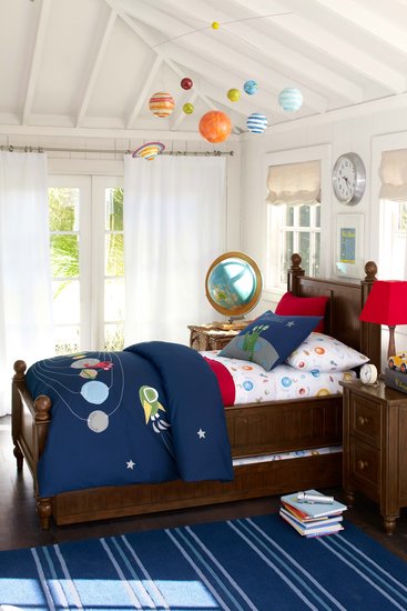Your big boy's room may already be the final frontier when it comes to keeping a clean house, and now it can look like that even when it's clean. We love the new Nathan bedding collection complete with planets, stars, and even the requisite alien. What also drew me to this room is the solar system mobile hanging from the ceiling. Most mamas move away from mobiles when tots leave their cribs (or before!), but this one helps complete the room and carry the space theme up to the ceiling.
Your big boy's room may already be the final frontier when it comes to keeping a clean house, and now it can look like that even when it's clean. We love the new Nathan bedding collection complete with planets, stars, and even the requisite alien. What also drew me to this room is the solar system mobile hanging from the ceiling. Most mamas move away from mobiles when tots leave their cribs (or before!), but this one helps complete the room and carry the space theme up to the ceiling.
