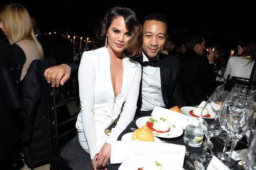 John Legend and Chrissy Teigen cuddled up during the amfAR New York Gala on Wednesday.
John Legend and Chrissy Teigen cuddled up during the amfAR New York Gala on Wednesday.