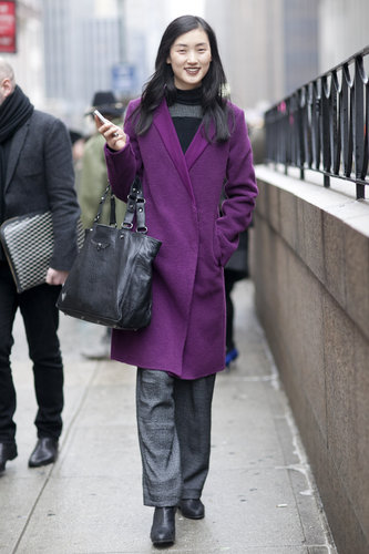 A plum-hued coat contrasted her moody charcoal grays.
A plum-hued coat contrasted her moody charcoal grays.