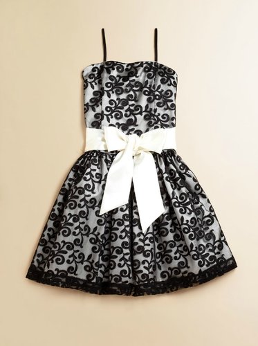 Your leading lady will turn heads in this black and white dress ($150) with a sweet bow and lace overlay.
Your leading lady will turn heads in this black and white dress ($150) with a sweet bow and lace overlay.
