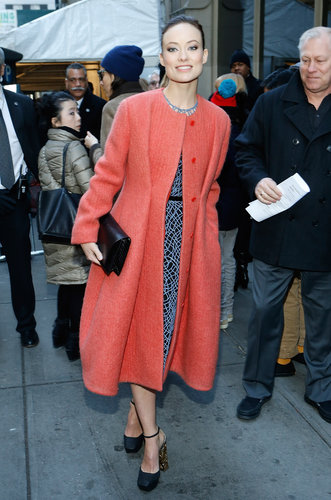 She topped her detailed dress with a punchy orange coat.
She topped her detailed dress with a punchy orange coat.