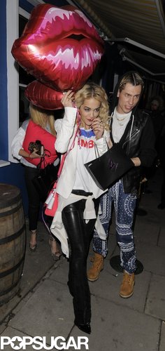 Rita Ora grabbed dinner in London with a group of friends while holding onto giant kiss balloons.
Rita Ora grabbed dinner in London with a group of friends while holding onto giant kiss balloons.
