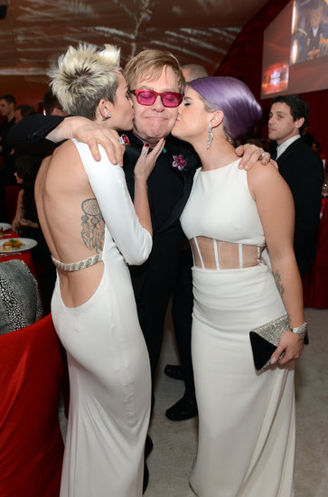 Miley Cyrus and Kelly Osbourne kissed Elton John on the cheek.
Miley Cyrus and Kelly Osbourne kissed Elton John on the cheek.