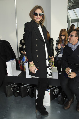 Looking every bit the trendsetter, Olivia posed in a window pane plaid Tibi dress, black coat, over-the-knee suede boots, and funky cat-eye shades at Antonio Berardi at LFW.
Looking every bit the trendsetter, Olivia posed in a window pane plaid Tibi dress, black coat, over-the-knee suede boots, and funky cat-eye shades at Antonio Berardi at LFW.