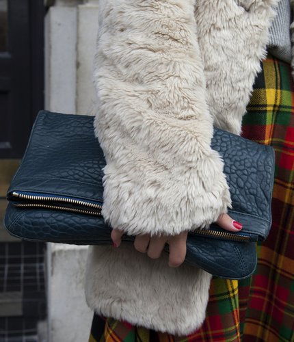 A textural fold-over clutch was paired with a fur coat and plaid trousers for a lesson in Winter layers.
A textural fold-over clutch was paired with a fur coat and plaid trousers for a lesson in Winter layers.