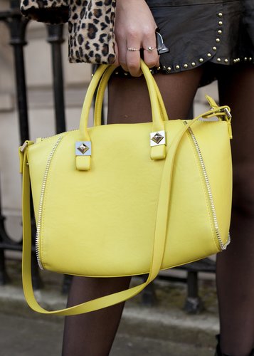 A bright yellow satchel added a cheery pop of color to this LFW look.
A bright yellow satchel added a cheery pop of color to this LFW look.