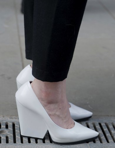White pointy-toe pumps popped against black cropped trousers.
White pointy-toe pumps popped against black cropped trousers.