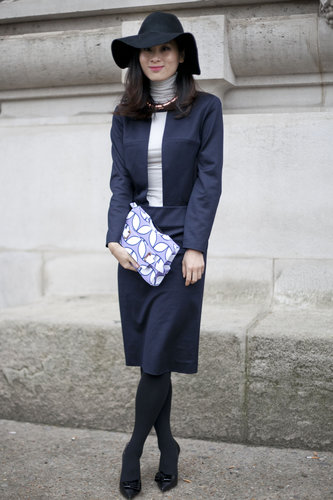 This showgoer winterized a sharp sheath with a turtleneck layered up underneath and added a floppy fedora for a little style whimsy.
This showgoer winterized a sharp sheath with a turtleneck layered up underneath and added a floppy fedora for a little style whimsy.