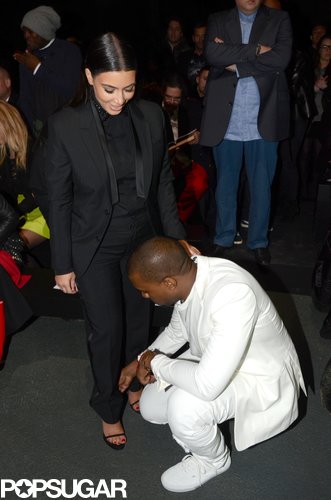 Kanye West helped Kim Kardashian with her shoe after attending a Givenchy show together in Paris in March 2013.
Kanye West helped Kim Kardashian with her shoe after attending a Givenchy show together in Paris in March 2013.
