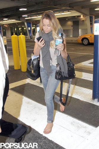 Lauren Conrad wore a scarf over her t-shirt as she arrived in Miami.
Lauren Conrad wore a scarf over her t-shirt as she arrived in Miami.