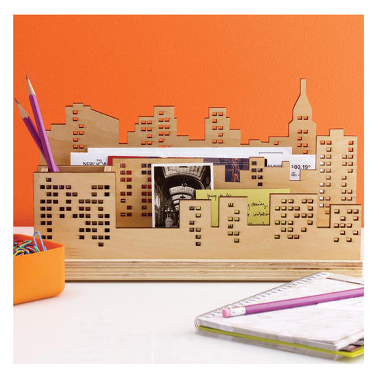 Keep everything neat and in place thanks to this laser-cut wood skyline desk organizer ($25) that comes with a pen holder and three slots for mail and messages.
Keep everything neat and in place thanks to this laser-cut wood skyline desk organizer ($25) that comes with a pen holder and three slots for mail and messages.