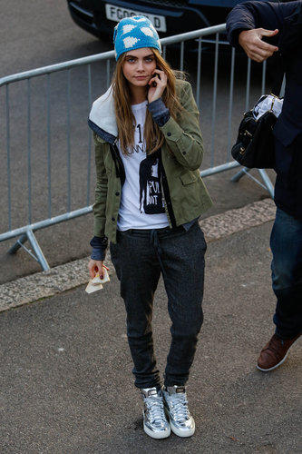 Cara Delevingne wore a blue printed knit beanie, an army-green anorak, and shiny silver sneakers during London Fashion Week.
Cara Delevingne wore a blue printed knit beanie, an army-green anorak, and shiny silver sneakers during London Fashion Week.