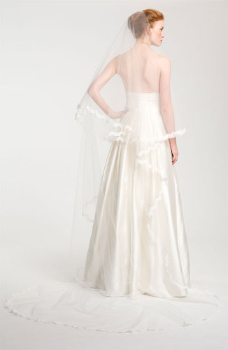 Lace detailing adds an extraromantic touch to this Nina Angela cathedral veil ($1,250).
Lace detailing adds an extraromantic touch to this Nina Angela cathedral veil ($1,250).