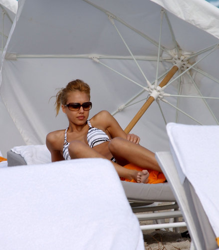 Jessica Alba relaxed in shades and a striped bikini in South Beach in January 2005.
Jessica Alba relaxed in shades and a striped bikini in South Beach in January 2005.