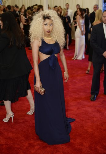 Nicki Minaj posed in her navy Tommy Hilfiger cutout dress and gold studded clutch.
Nicki Minaj posed in her navy Tommy Hilfiger cutout dress and gold studded clutch.