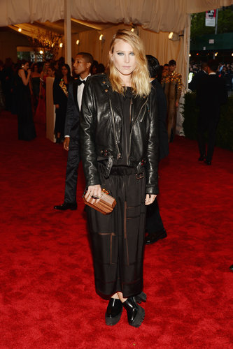 Dree Hemingway added a black leather biker jacket to her black sheer maxi dress, then added an au naturel touch via a wooden clutch.
Dree Hemingway added a black leather biker jacket to her black sheer maxi dress, then added an au naturel touch via a wooden clutch.