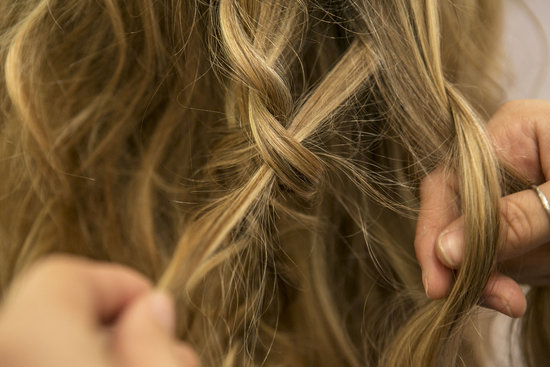 Next, take another small section of hair that's next to the other braid (should be right in the center of your head) and begin a new braid. Be sure to loop random pieces of the new braid into the first one you created to join them together.
Next, take another small section of hair that's next to the other braid (should be right in the center of your head) and begin a new braid. Be sure to loop random pieces of the new braid into the first one you created to join them together.