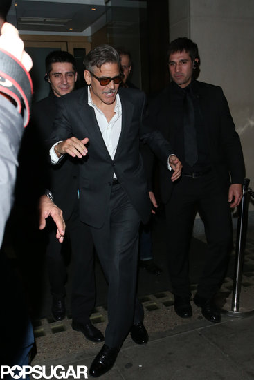 George Clooney appeared to trip over his own two feet leaving Nobu restaurant in London.
George Clooney appeared to trip over his own two feet leaving Nobu restaurant in London.