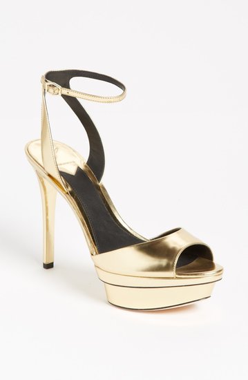 Instead of opting for a traditional white heel, go for gold in these sleek B Brian Atwood gold ankle-strap sandals ($325).
Instead of opting for a traditional white heel, go for gold in these sleek B Brian Atwood gold ankle-strap sandals ($325).